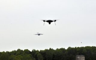 a photo of two drones flying in the sky